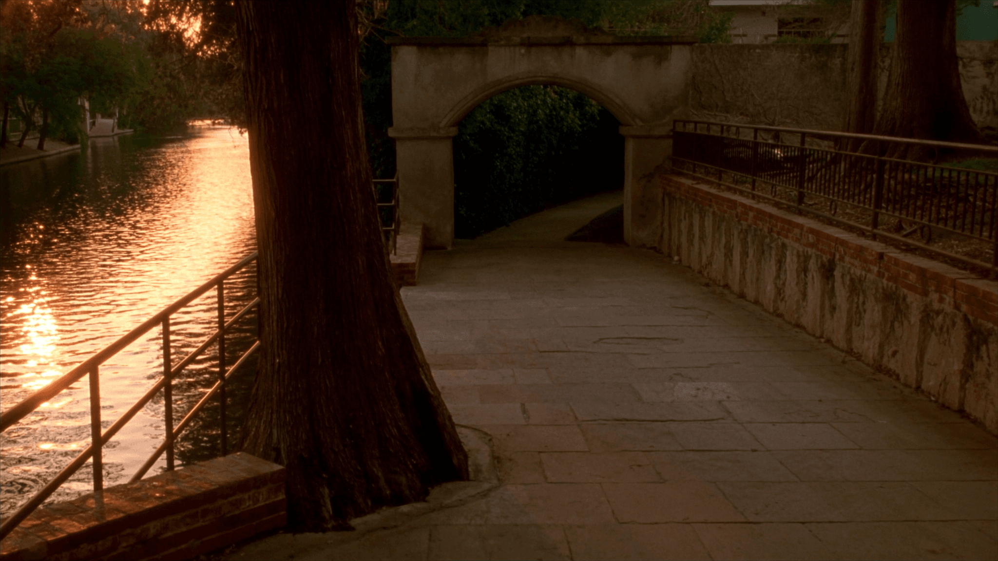 San Antonio River Walk stone path and archway at sunset